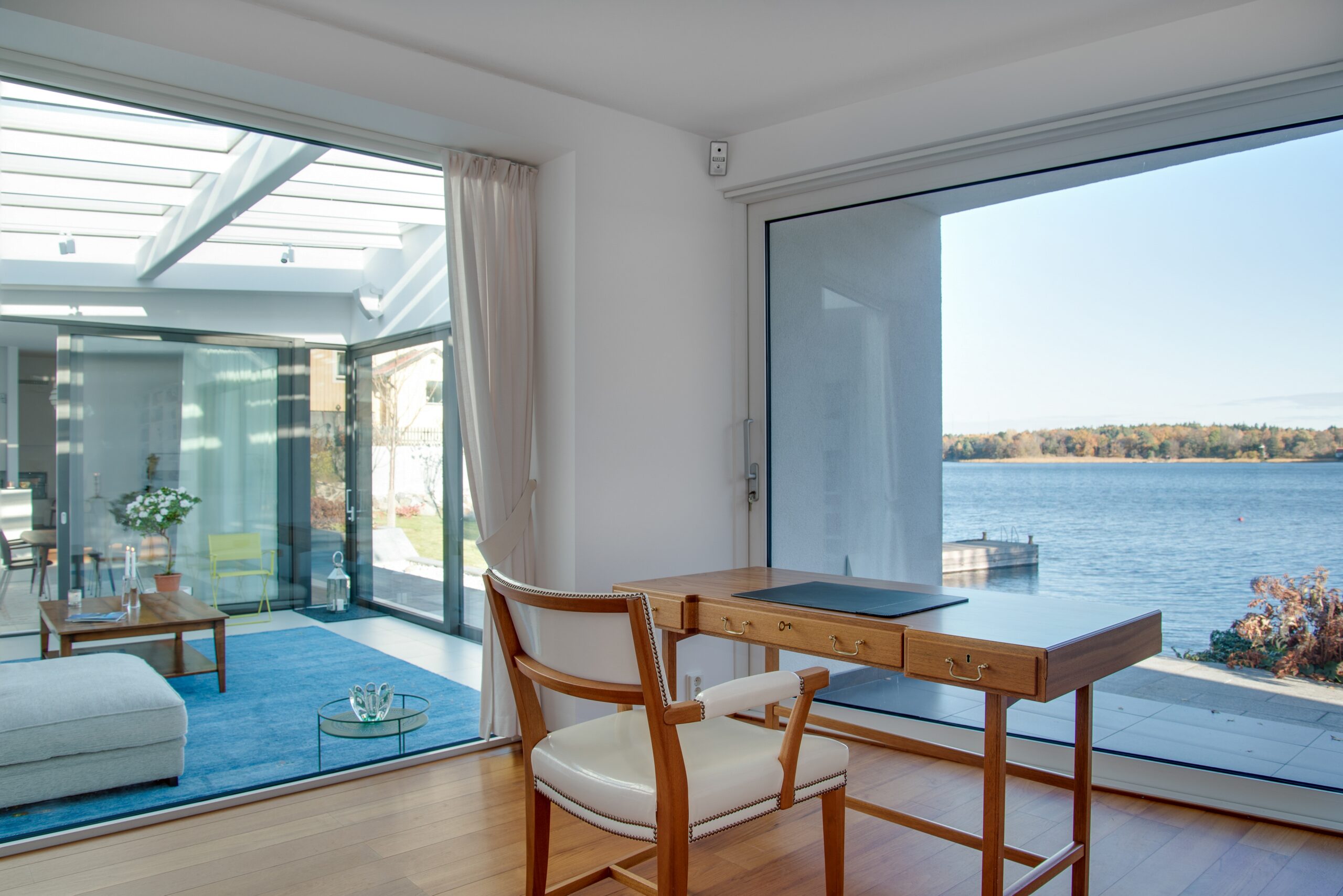 luxury beach house with glass windows and the beautiful scenery of the sea in the background